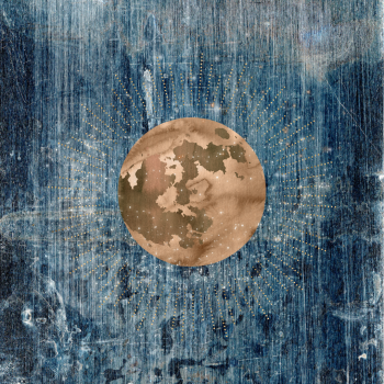 Small gold moon on denim background